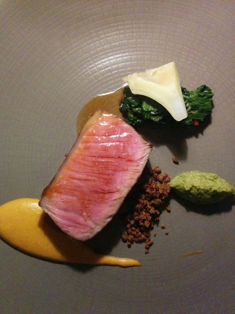 Lamb loin with globe artichoke barigoule, green olive and harissa