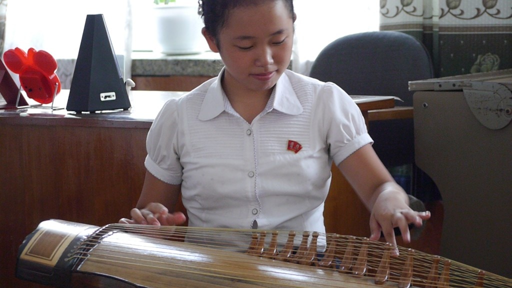 Child plays a traditional instrument