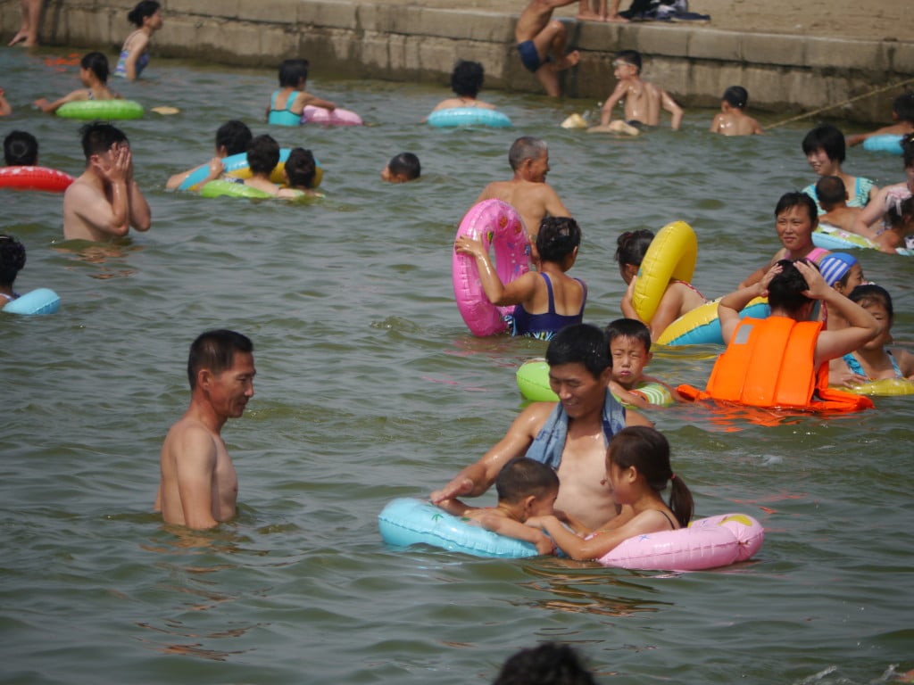 Kids and adults playing in the water