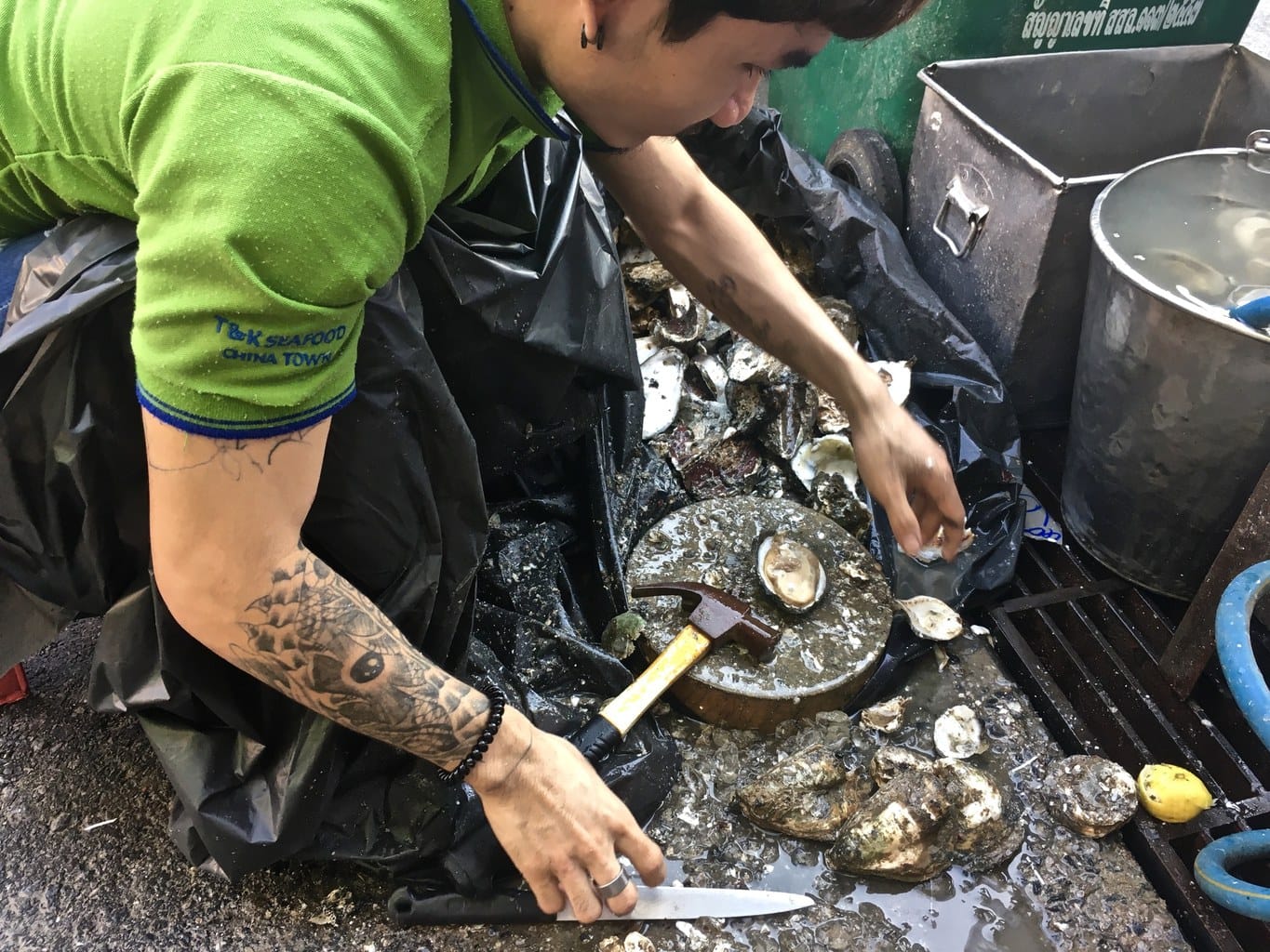 Shucking oysters in Bangkok Chinatown