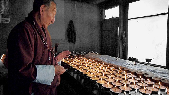 Lighting butter lamps in Bhutan