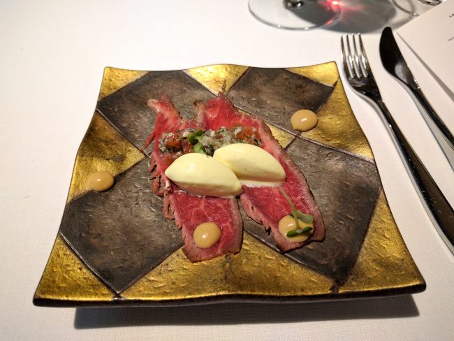 Slices of Iberian presa on foie-gras curd