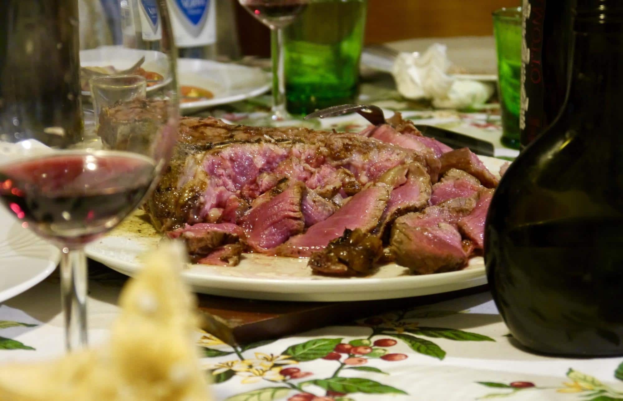 A Florentine steak with a glass of Brunello di Montalcino enjoyed at an Italian home