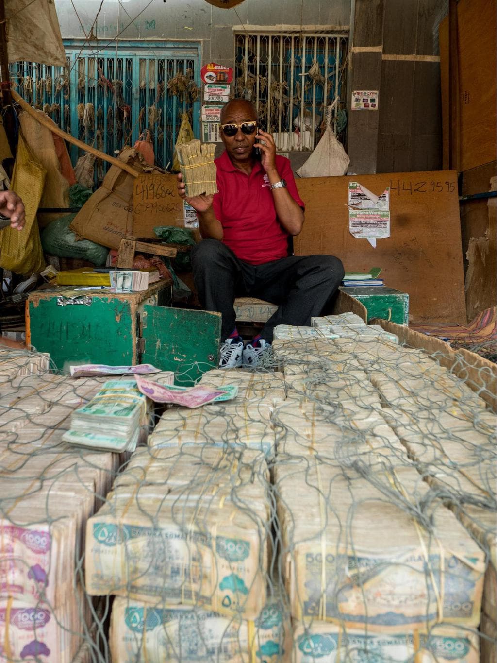 Money changer showing me his stack of Somali Shilling