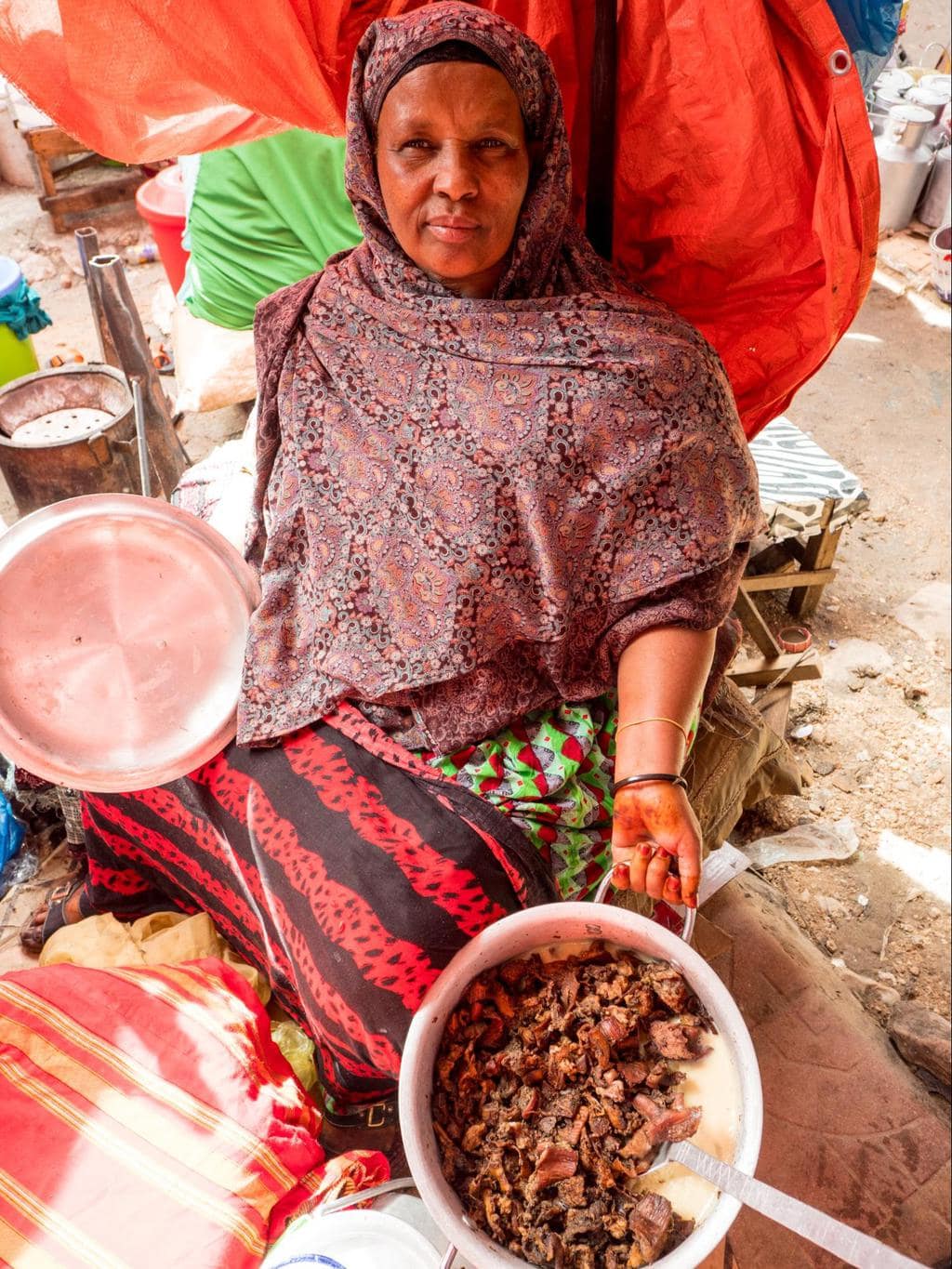 Somalilander market seller with her camel liver