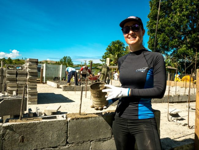 Helping out at the community school project laying bricks