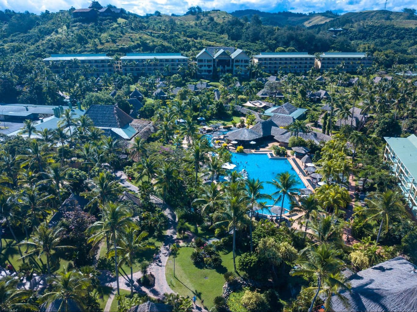 The main building and pool at Outrigger Fiji Beach Resort