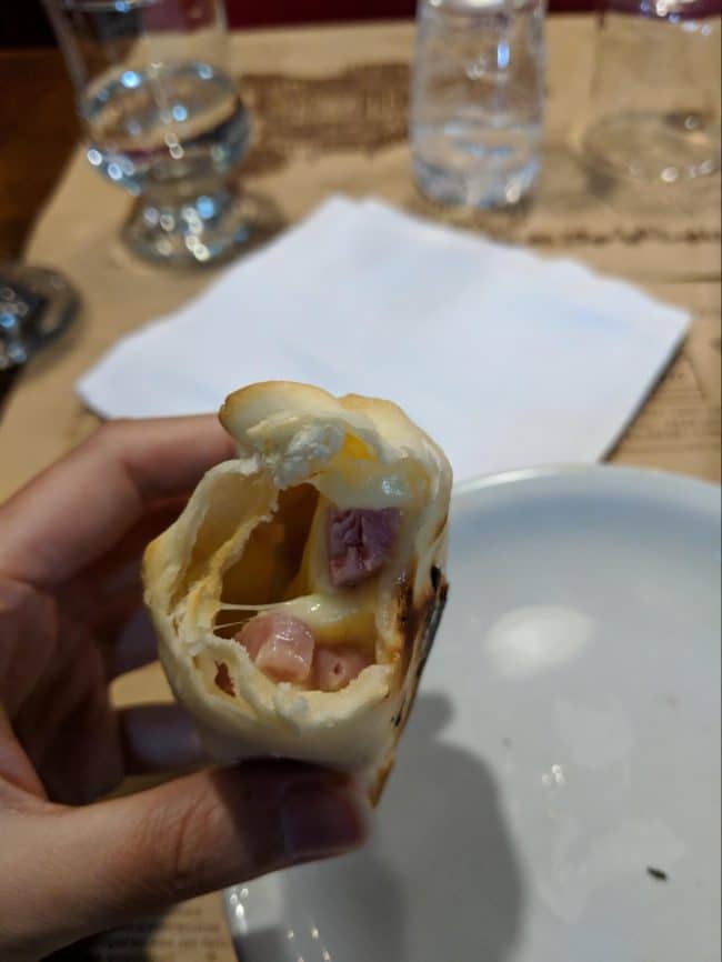 Inside an Argentinian beef, cheese and ham empanada