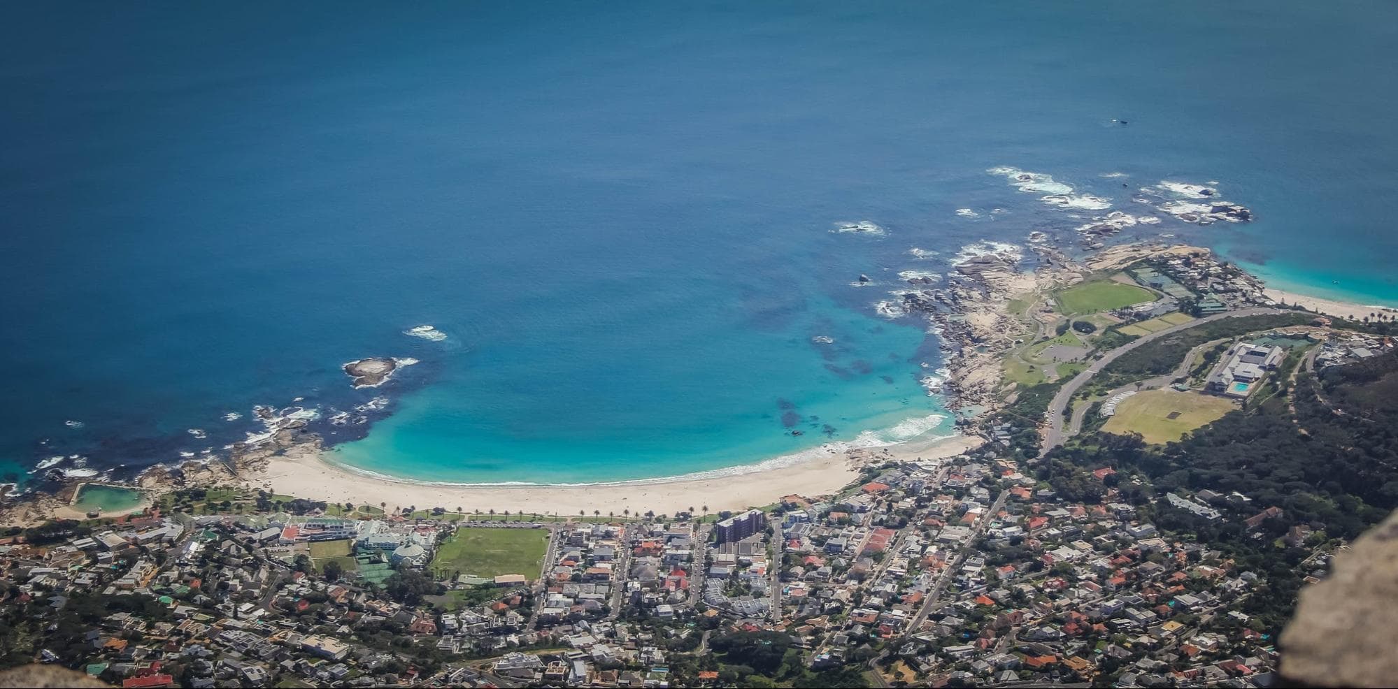 Camps Bay beach from above, with Clifton 4 in the right corner