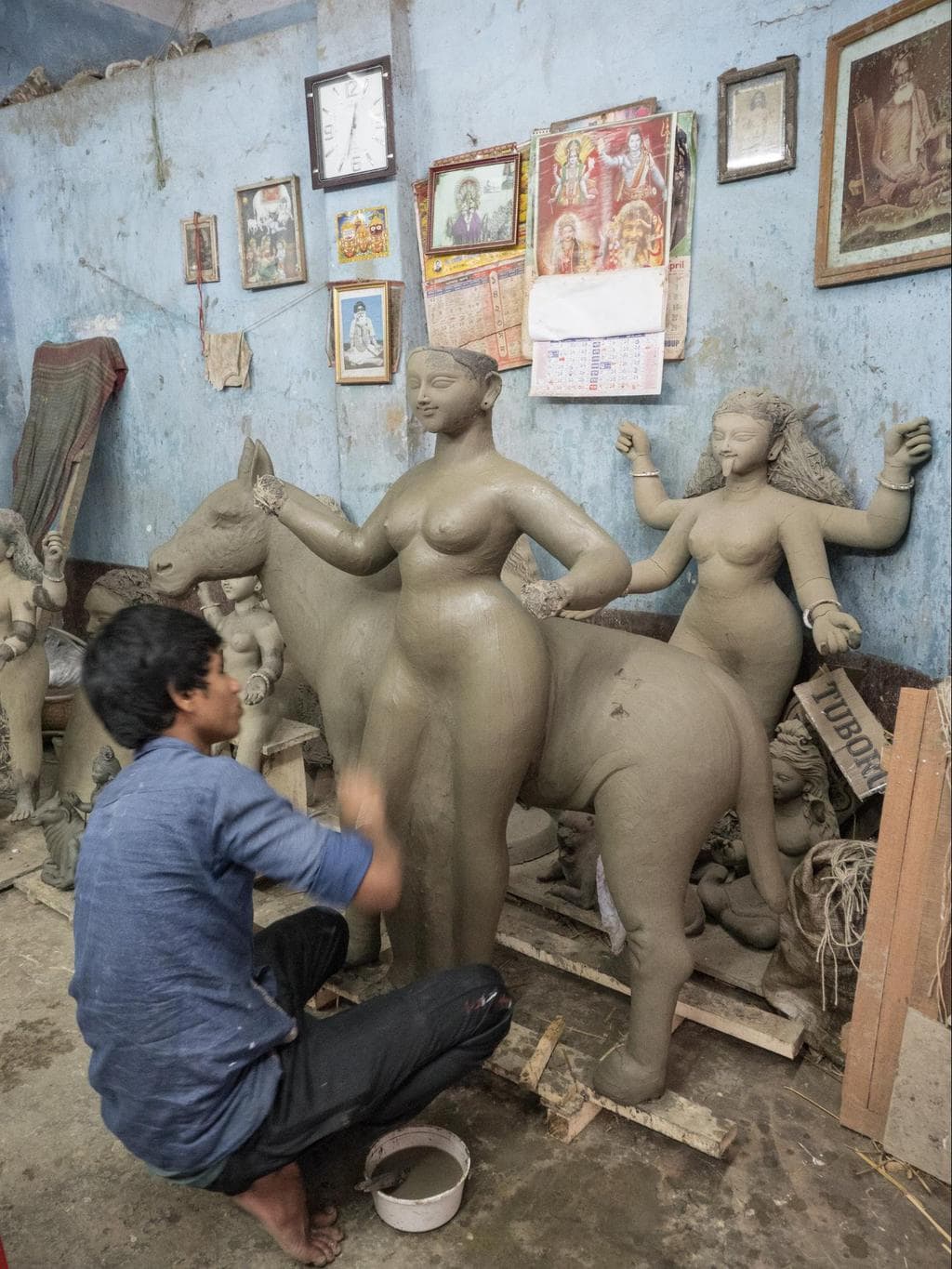 An artist making Hindu God statues