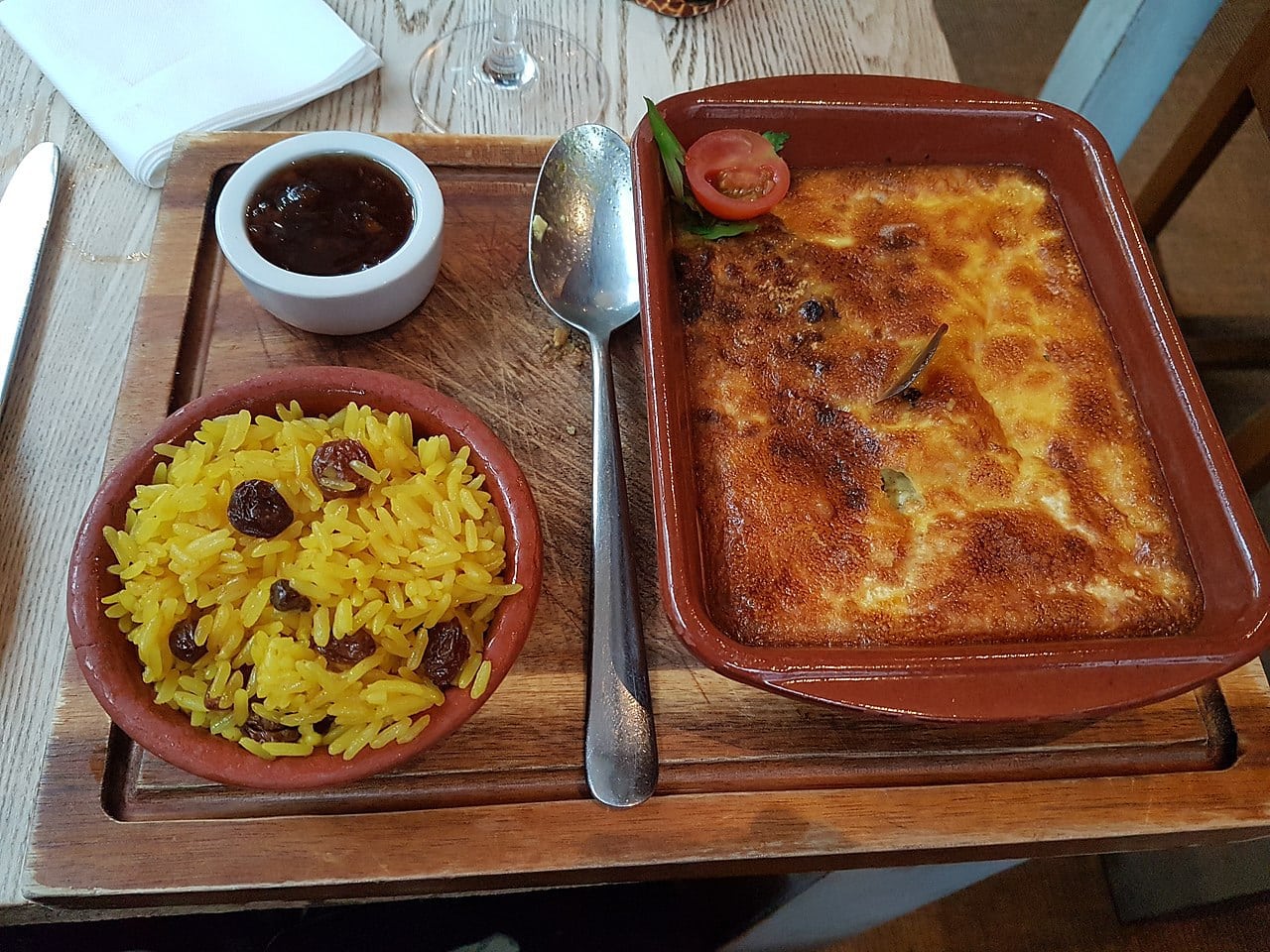 Bobotie with a side of yellow rice and some Mrs Ball’s chutney. Wikipedia CharmaineZoe's Marvelous Melange (CC BY 2.0)