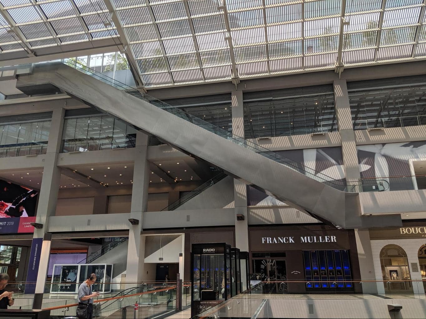 Escalators inside Shoppes at Marina Bay Sands to Gardens by the Bay from the side