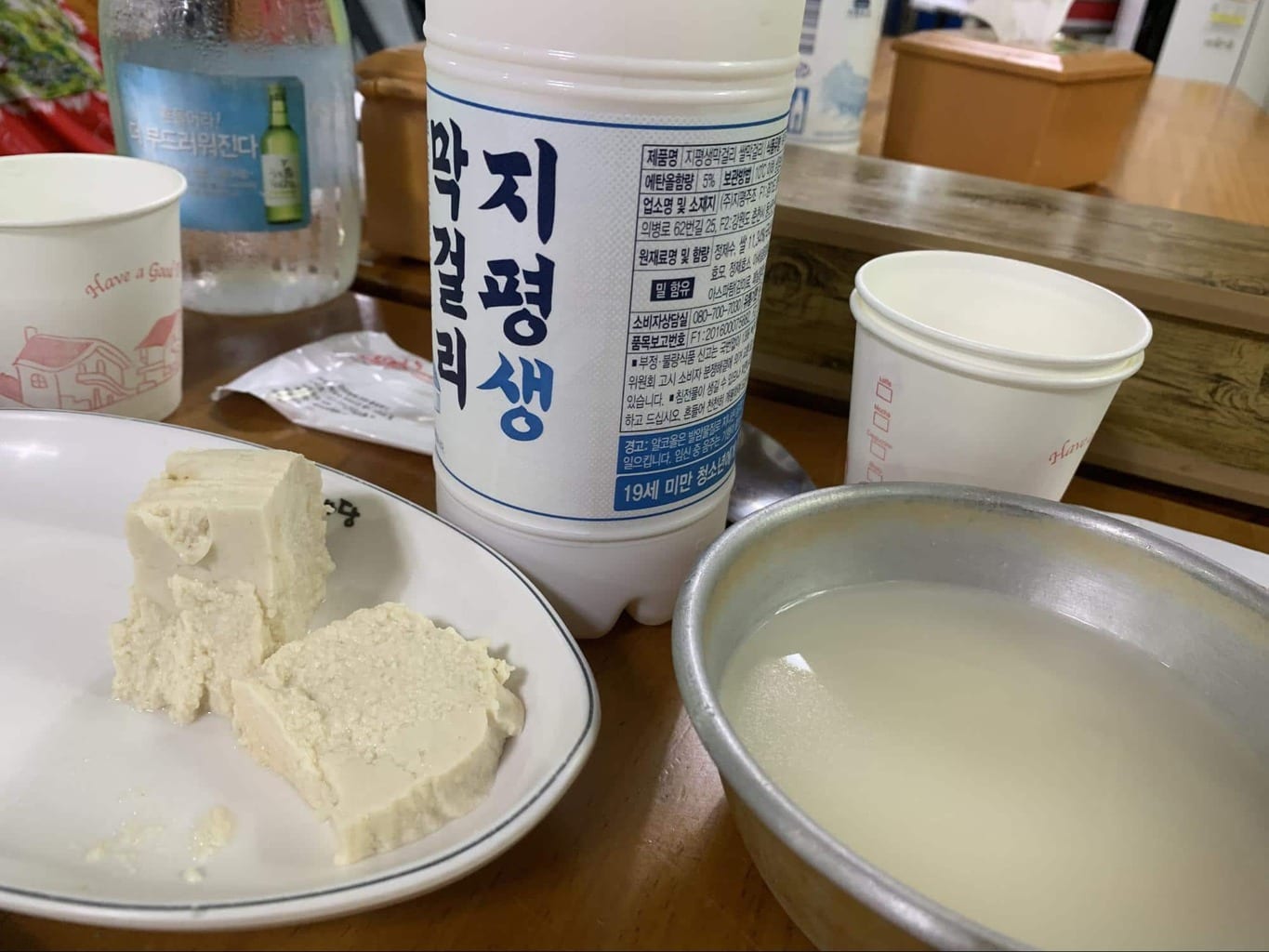 Makgeolli served in a bowl with fresh tofu