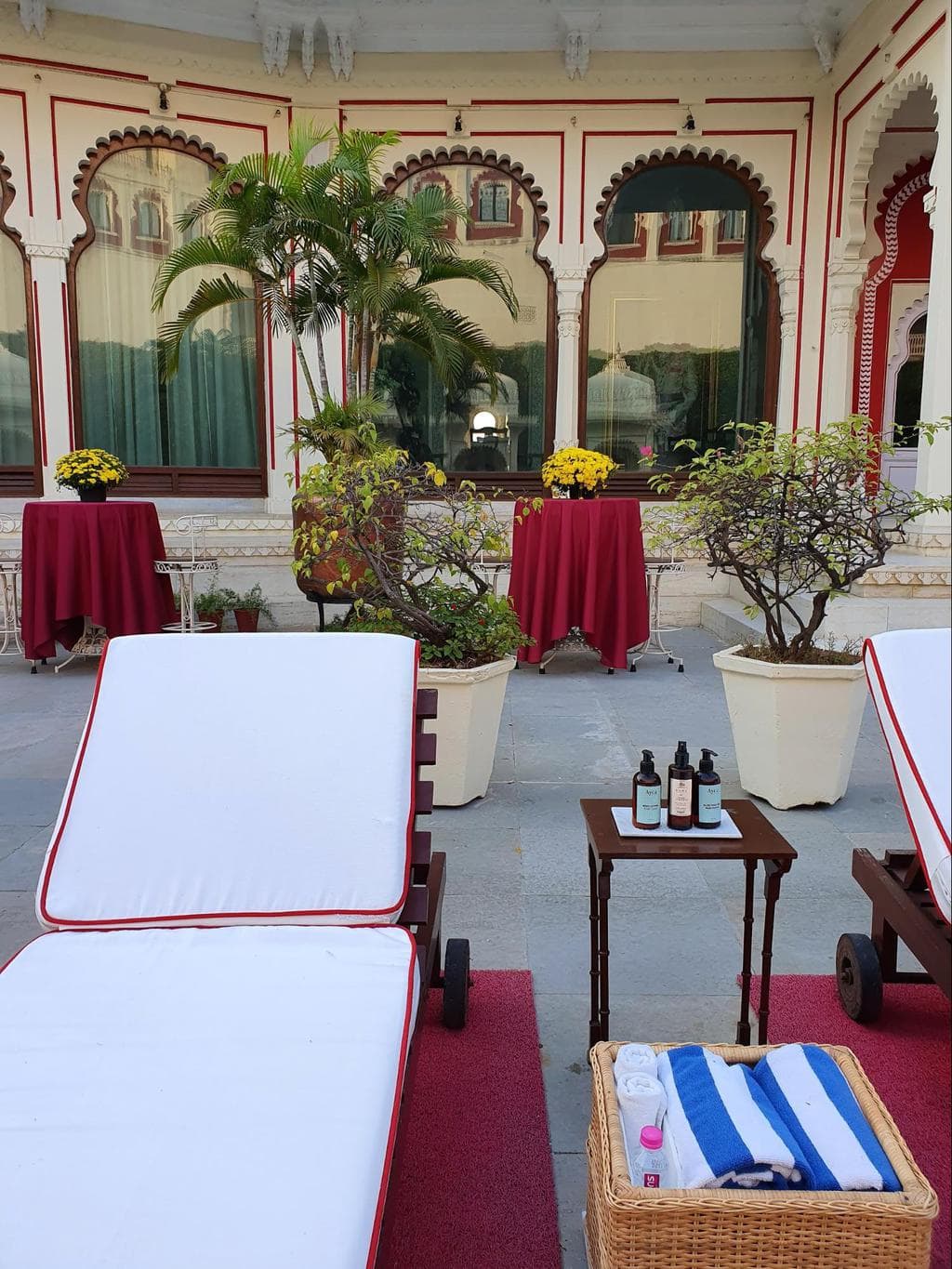 Sun loungers by the pool at Shiv Niwas Palace