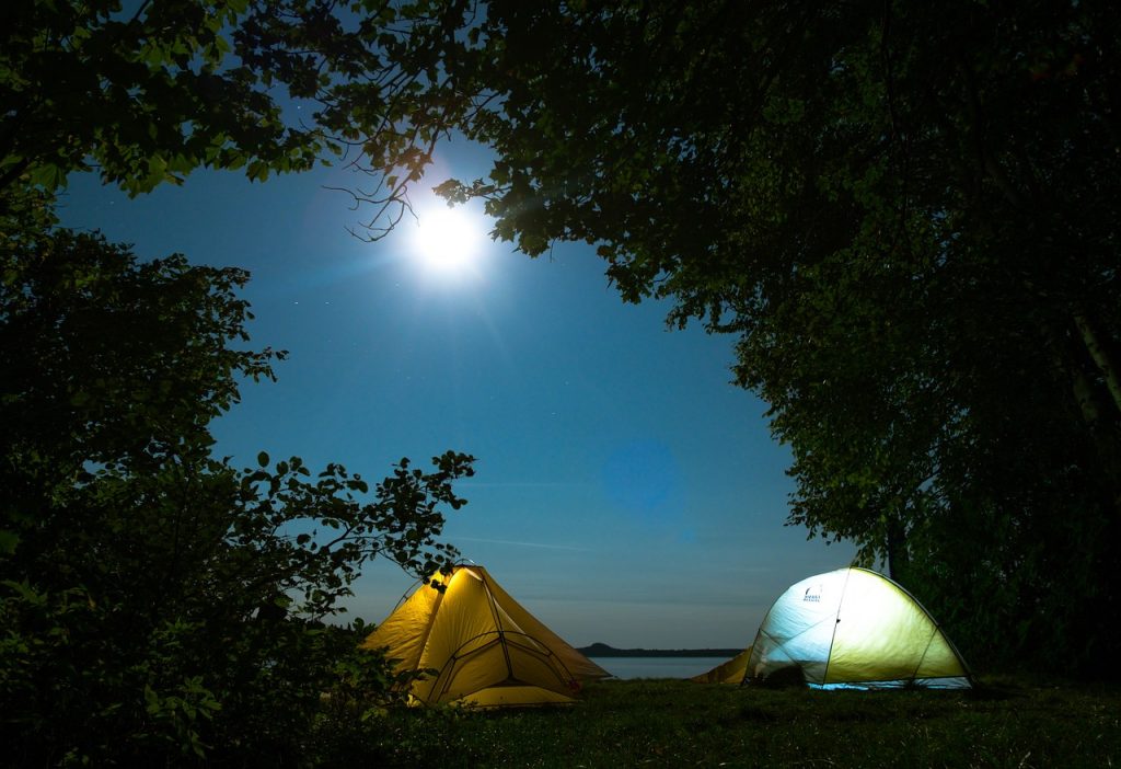 Pitching a tent at night while camping in Singapore