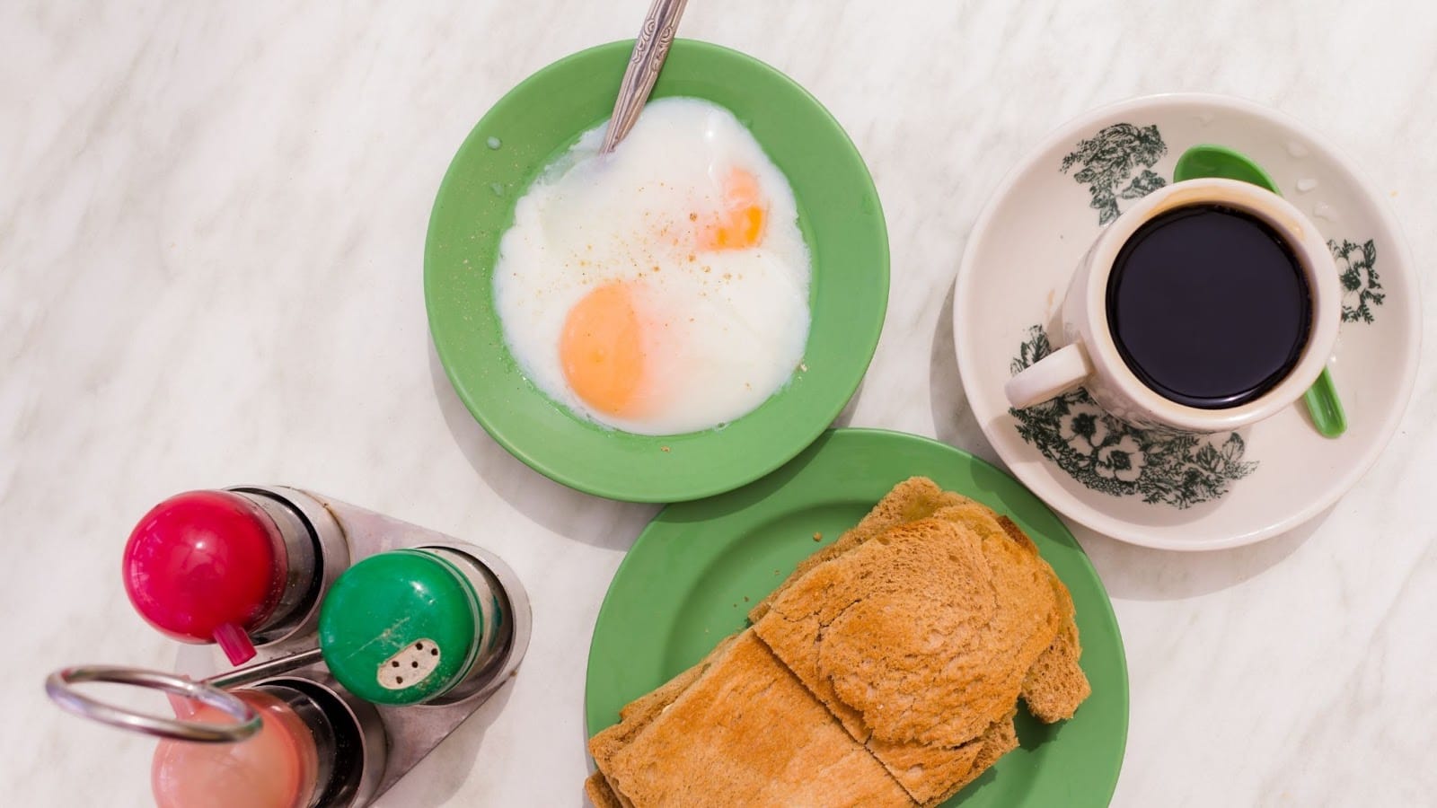 Traditional Singaporean breakfast of kopi, kaya toast and 2 runny eggs